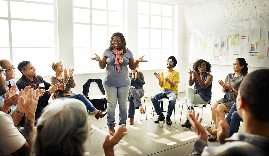 Woman talking to a group of people interested in participatory medicine